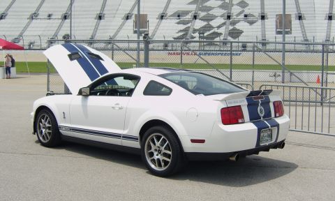 2007 Ford Mustang - White 2007 Ford Mustang Shelby GT500 parked at Nashville Superspeedway with its hood up.