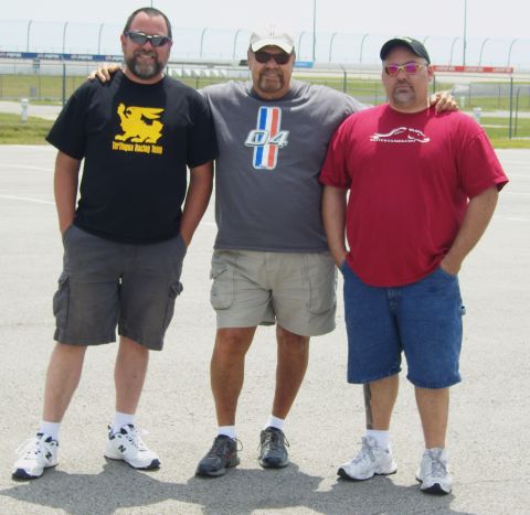 2007 Ford Mustang - Three men pose for a photo at a racetrack, possibly during an event.