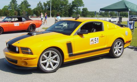 2007 Ford Mustang - A yellow 2007 Ford Mustang GT, identified by its body style and racing number 51, is parked at an event.