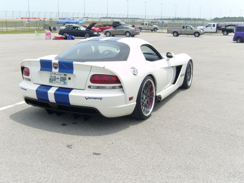 2007 Ford Mustang - A white Dodge Viper with racing stripes is parked on asphalt at a track event.