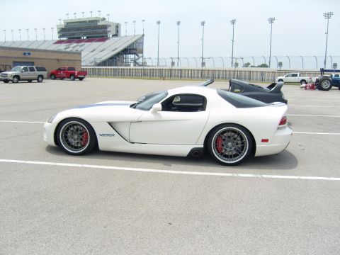 2007 Ford Mustang - A white Dodge Viper is parked on asphalt with a racetrack grandstand in the background.