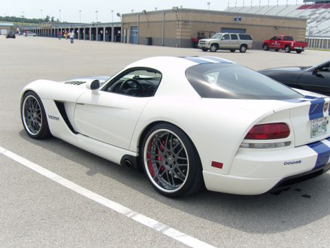 2007 Ford Mustang - A white Dodge Viper with blue racing stripes is parked on asphalt at a racetrack.