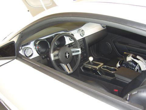 2007 Ford Mustang - Interior view of a white car, showing the dashboard, steering wheel, and a racing helmet.