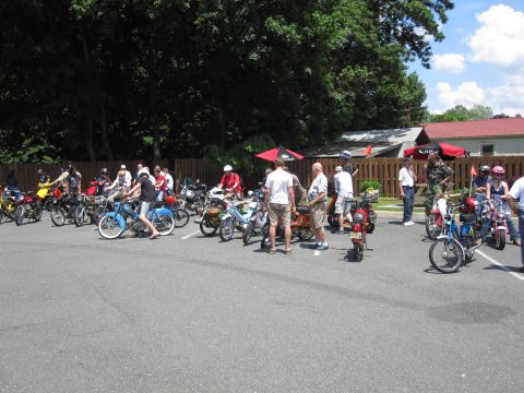 1981 Garelli Rally Sport - A gathering of various mopeds is seen parked in an outdoor lot on a sunny day.