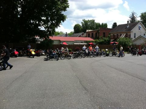 1981 Garelli Rally Sport - A gathering of mopeds in a parking lot on a sunny day.