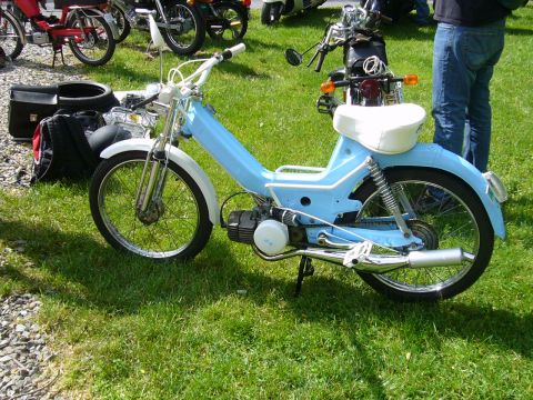 1981 Garelli Rally Sport - A light blue moped with white accents is parked on a grassy field alongside other motorcycles.