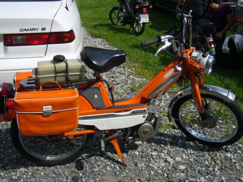 1981 Garelli Rally Sport - An orange moped is parked next to a white car, with another moped in the background.