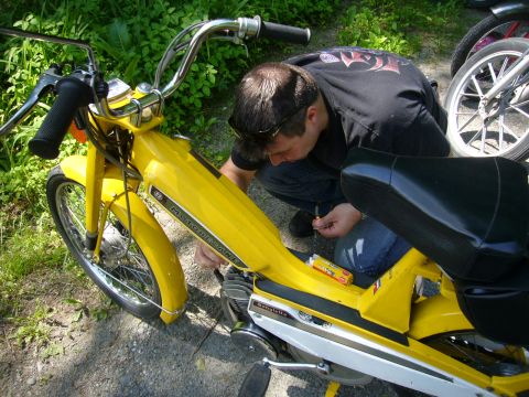 1981 Garelli Rally Sport - A person works on a yellow moped, with another moped partially visible in the background.