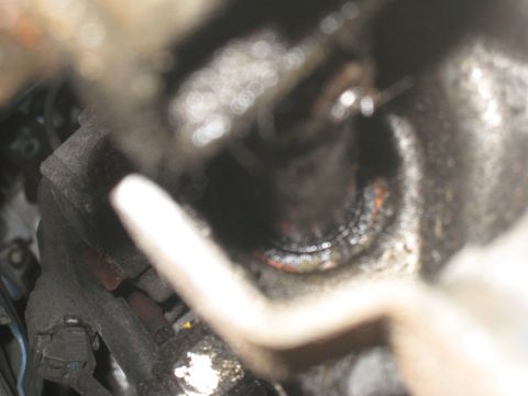 2007 Subaru Impreza - Close-up of a greasy mechanical part, likely from a vehicle's engine bay.
