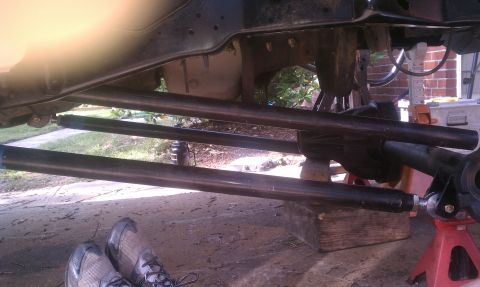 1990 Ford Bronco - Vehicle suspension components are visible while the vehicle is supported by jack stands.