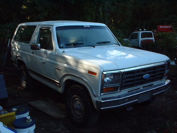 White 1978 Ford Bronco parked outdoors, front quarter view, with another vehicle in the background