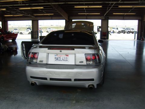 2007 Ford Mustang - A silver Saleen Mustang is parked in a garage with its hood open, showing the rear of the vehicle.