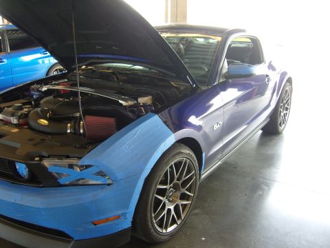 2007 Ford Mustang - A purple Mustang, likely from the 2010-2014 generation, is shown with its hood open and blue tape covering the front fender.