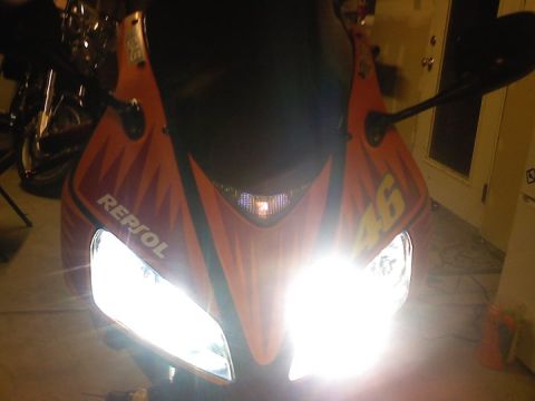 2006 Honda CBR-RR - A motorcycle with its headlights illuminated, Repsol branding and the number 46 on its fairing.