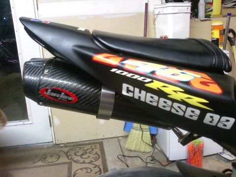 2006 Honda CBR-RR - A close-up view of a motorcycle's tail section and aftermarket exhaust system.