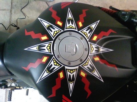 2006 Honda CBR-RR - Motorcycle fuel tank features a custom sunburst graphic design with a central fuel cap.
