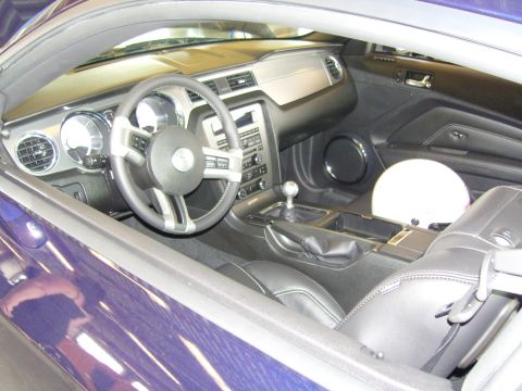 2007 Ford Mustang - The interior of a modern car, a manual transmission and a white helmet resting on the passenger seat.