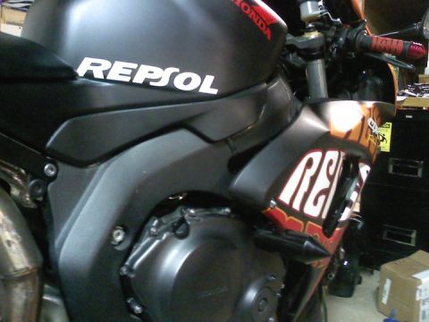 2006 Honda CBR-RR - Motorcycle fairing detail showing Repsol and Honda branding.