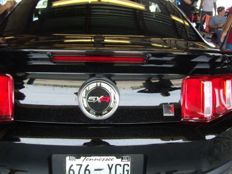 2007 Ford Mustang - Rear view of a black 2007 Ford Mustang showing the 5.0 badge and Roush branding.