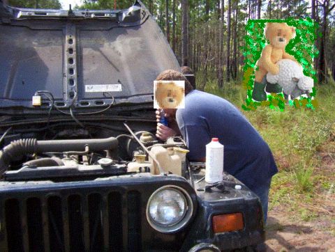 1991 Ford Bronco - A person is attending to the engine compartment of a vehicle, with the hood open.