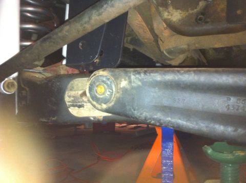 1990 Ford Bronco - Close-up of a vehicle's suspension component with part numbers visible.