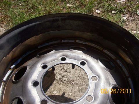 1982 Ford F-100 - A close-up view of a truck wheel rim, showing its construction and a timestamp.