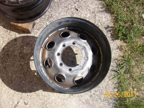 1982 Ford F-100 - A single steel wheel rim is shown resting on concrete, with grass in the background. The date 06/26/2011 is visible.