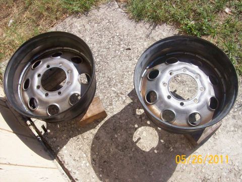 1982 Ford F-100 - Two steel truck wheels with multiple lug holes sit on concrete, with a date stamp of 05/26/2011.