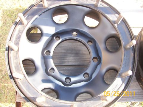 1982 Ford F-100 - A close-up view of a single truck wheel, showing its construction and lug nut mounting points.