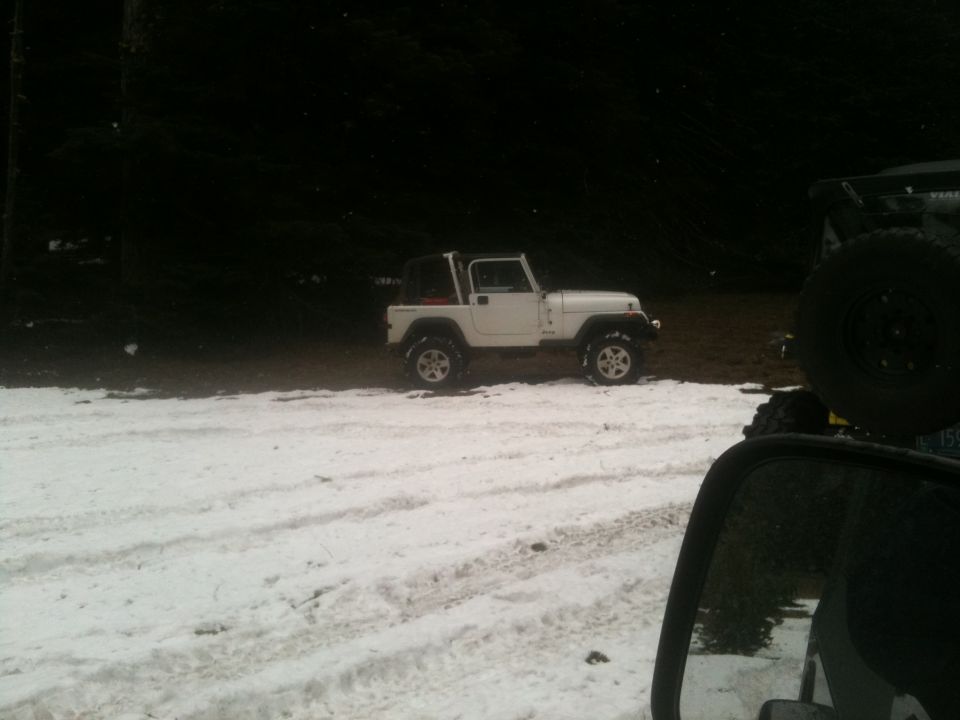 White Jeep Wrangler parked on snow, side view. 2005 Jeep Wrangler