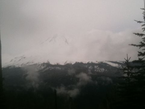 2005 Jeep Wrangler - A cloudy day view of a snow-covered mountain range with dark trees in the foreground.