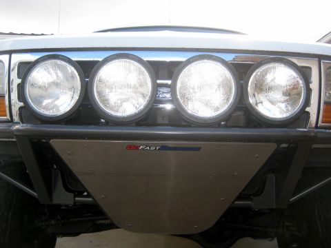 1996 Ford Bronco - Front view of a silver Ford Bronco with auxiliary lights and a custom skid plate, showing a 1992 model year.