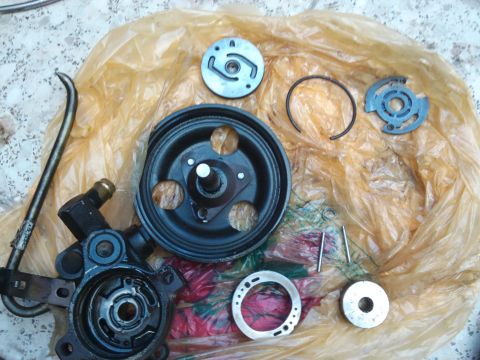 1998 Ford Crown Victoria - Disassembled power steering pump parts are spread out on a plastic bag.