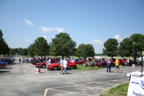 2007 Ford Mustang - A sunny day at a car show with numerous vehicles on display and attendees enjoying the event.