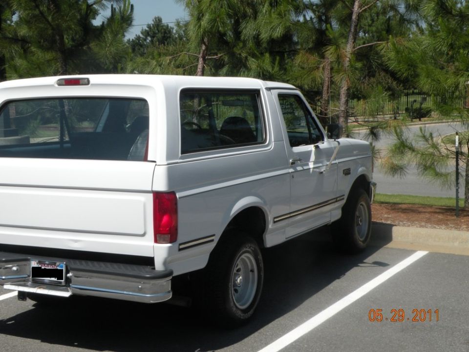 White 1996 Ford Bronco rear quarter view