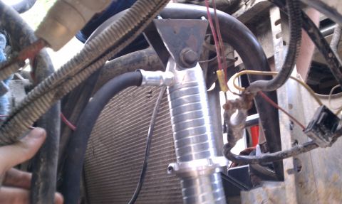 1990 Ford Bronco - Engine bay details show hoses, wiring, and a finned component near the radiator.