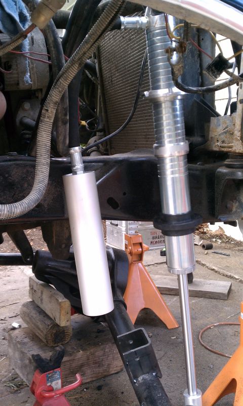 1990 Ford Bronco - Vehicle suspension components and radiator are visible, supported by jack stands.