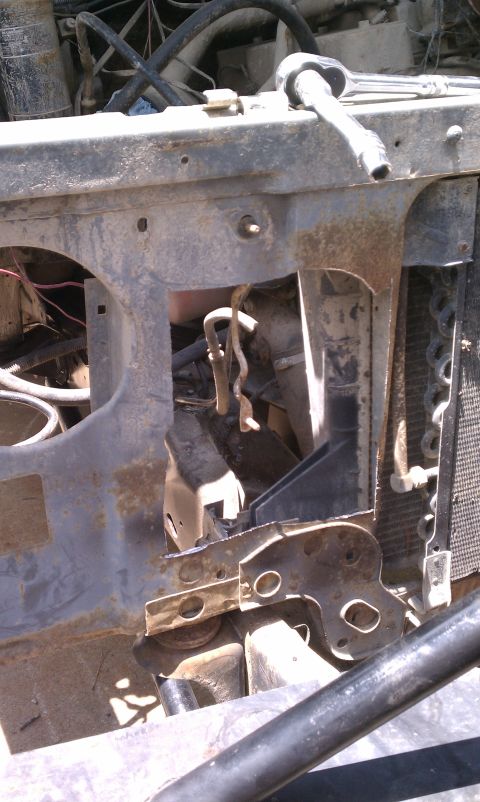 1990 Ford Bronco - Close-up view of a corroded engine bay, showing various mechanical parts and hoses.