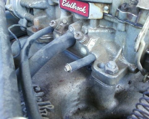1976 Ford Torino - A close-up view of a carburetor, identified by an Edelbrock label, shows various hoses and mechanical components.