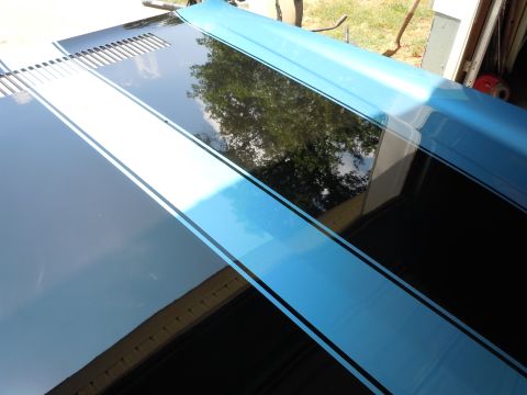 1972 Chevrolet Camaro - Hood with racing stripes, possibly from a 1972 Chevrolet Camaro, features louvers and a blue accent stripe.