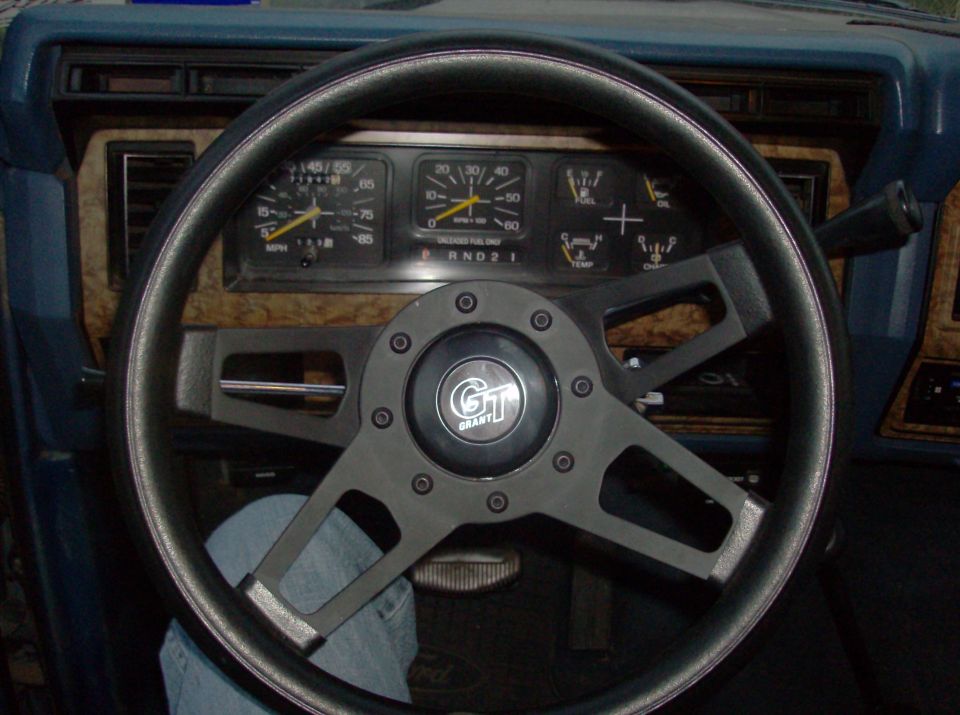 1986 Ford Bronco interior with Grant steering wheel and wood-grain dash