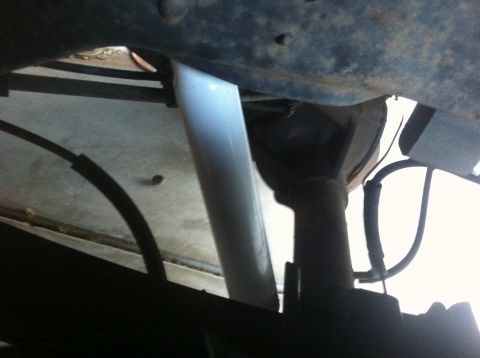 1990 Ford Bronco - Underside view of a vehicle's rear suspension, focusing on the shock absorber.