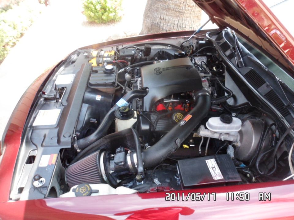 Red 2000 Ford Crown Victoria engine bay with aftermarket air intake