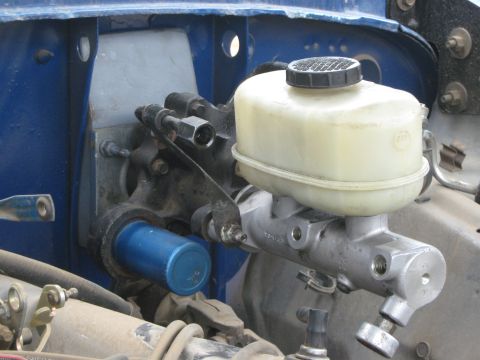 1978 Ford Bronco - Close-up of a brake master cylinder and reservoir assembly, likely from an older vehicle.