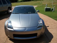 1996 Ford Bronco - Front view of a silver Nissan 350Z parked on a concrete driveway.