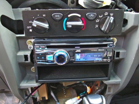 2002 Toyota 4Runner - JVC stereo installed in a vehicle's dashboard, alongside climate control knobs.