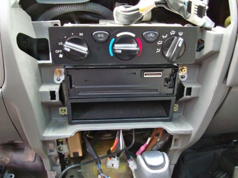 2002 Toyota 4Runner - Interior view of a car's dashboard with climate controls and an aftermarket stereo installation area.