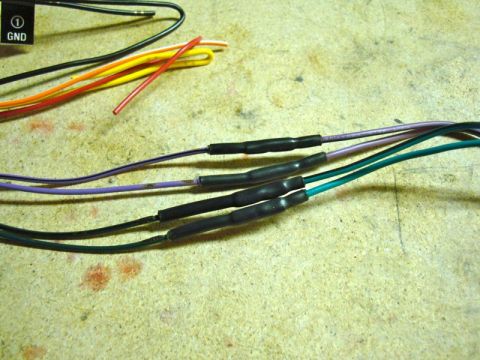 2002 Toyota 4Runner - Close-up of spliced and heat-shrunk wires, likely for an aftermarket car stereo installation.
