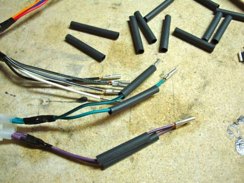 2002 Toyota 4Runner - Close-up of a wiring harness being prepped with heat shrink tubing for electrical connections.