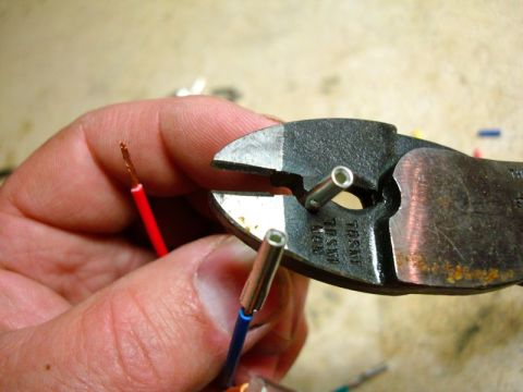 2002 Toyota 4Runner - Crimping wire connectors onto red and blue wires using pliers.